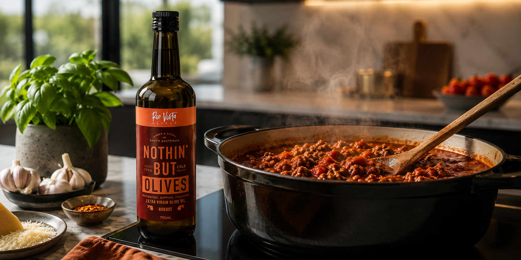 Olive oil bottle on a kitchen counter with a crock pot of chilli and a jar of basil leaves